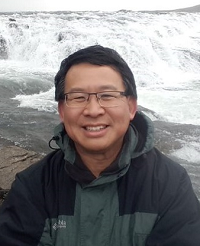 Luke Chung in front of waterfall in Iceland